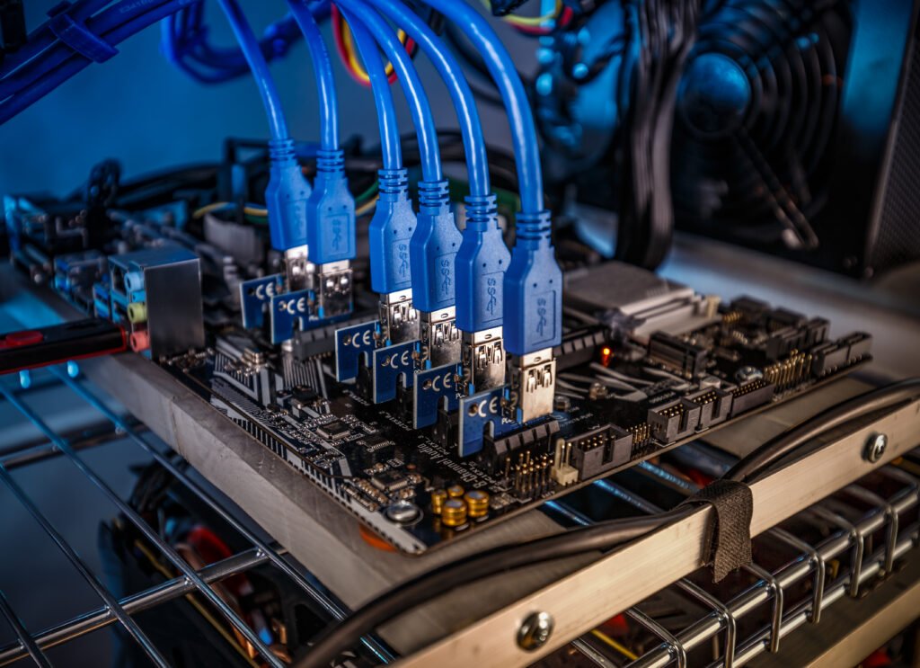 Computer motherboard with multiple blue network cables connected, representing advanced data systems and technology infrastructure.