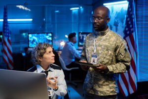 Military veteran collaborating with a professional in an operations center.