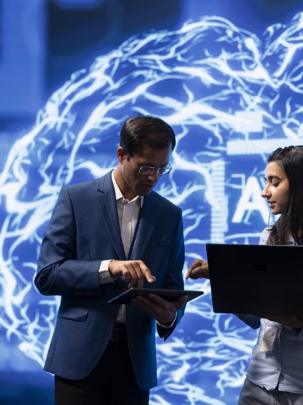 Two professionals reviewing documents together in a meeting setting.